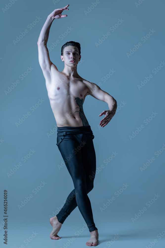 Obraz premium Young and graceful male ballet dancer isolated on old navy studio background. Art, motion, action, flexibility, inspiration concept.