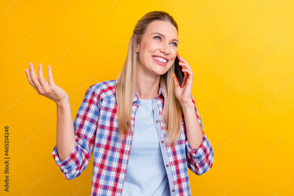 Photo of funny blond young lady say telephone wear plaid shirt isolated on yellow color background Photo of funny blond young lady say telephone wear plaid shirt isolated on yellow color background