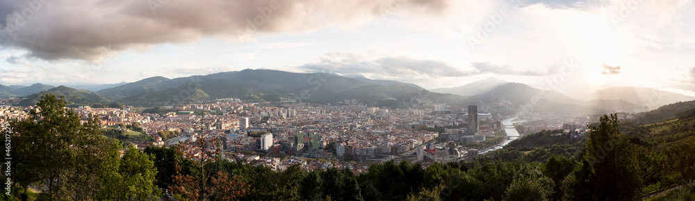 Spain, Biscay, Bilbao, Panorama of city at sunset with mountains in background Spain, Biscay, Bilbao, Panorama of city at sunset with mountains in background