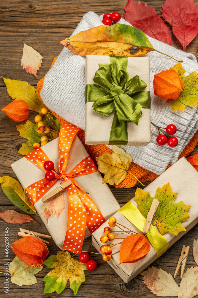 Zero waste gift concept with autumn design. Warm sweaters, fall leaves, thematic decor Zero waste gift concept with autumn design. Warm sweaters, fall leaves, thematic decor