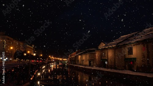 OTARU, HOKKAIDO, JAPAN : View of Otaru canal and falling snow. Japanese winter and romantic Christmas season concept. Night time shot. photo
