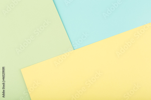 Elegant simple colored background made of light pastel green, yellow and mint blue background with copy space