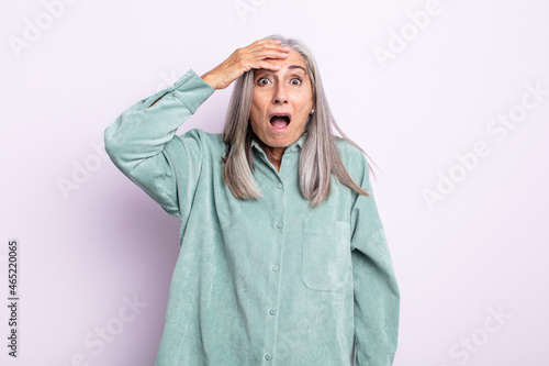 middle age gray hair woman panicking over a forgotten deadline, feeling stressed, having to cover up a mess or mistake