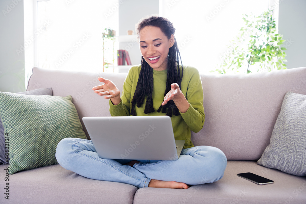 Fototapeta premium Full body photo of young happy woman sit sofa talk camera laptop inside house home indoors