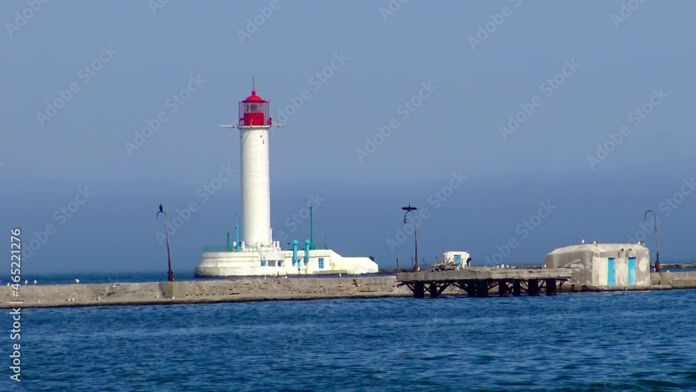 UKRAINE, ODESSA, APRIL 13, 2016: old lighthouse in the Odessa commercial seaport, Black Sea UKRAINE, ODESSA, APRIL 13, 2016: old lighthouse in the Odessa commercial seaport, Black Sea
