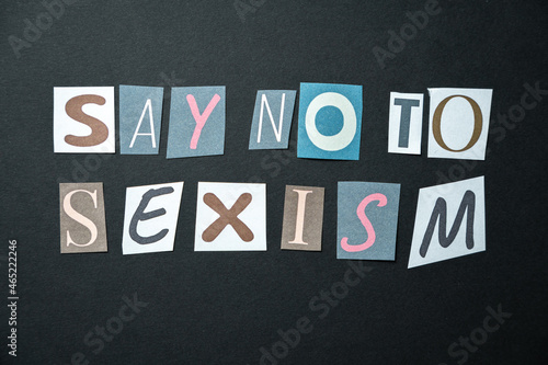 Say no to sexism words. Caption, heading made of letters with different fonts on a dark background.