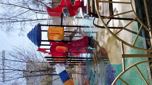 Cleaning team washes playground surfaces outside for cleanliness and disinfection, vertical video.