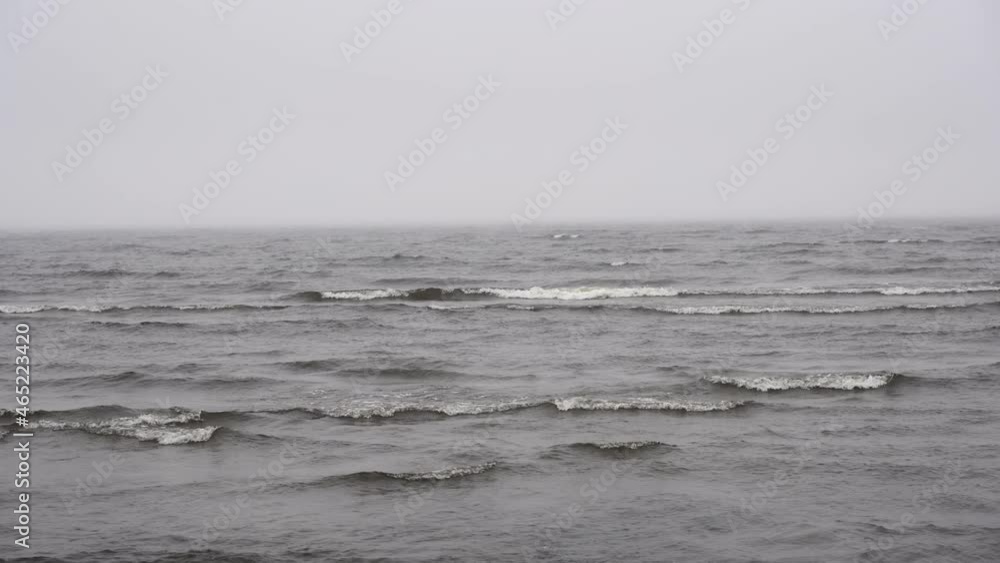 Sea in cloudy weather background. Gray sky and water on a gloomy sea coast landscape. Sea in cloudy weather background. Gray sky and water on a gloomy sea coast landscape.