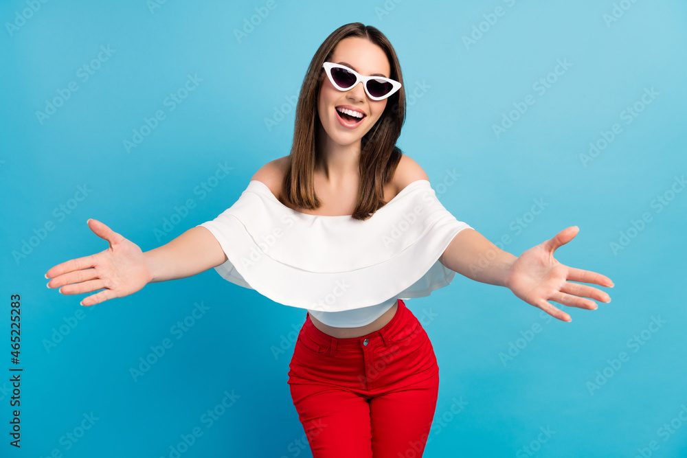 Photo of optimistic brunette milllennial lady want hug wear spectacles white top jeans isolated on blue color background Photo of optimistic brunette milllennial lady want hug wear spectacles white top jeans isolated on blue color background