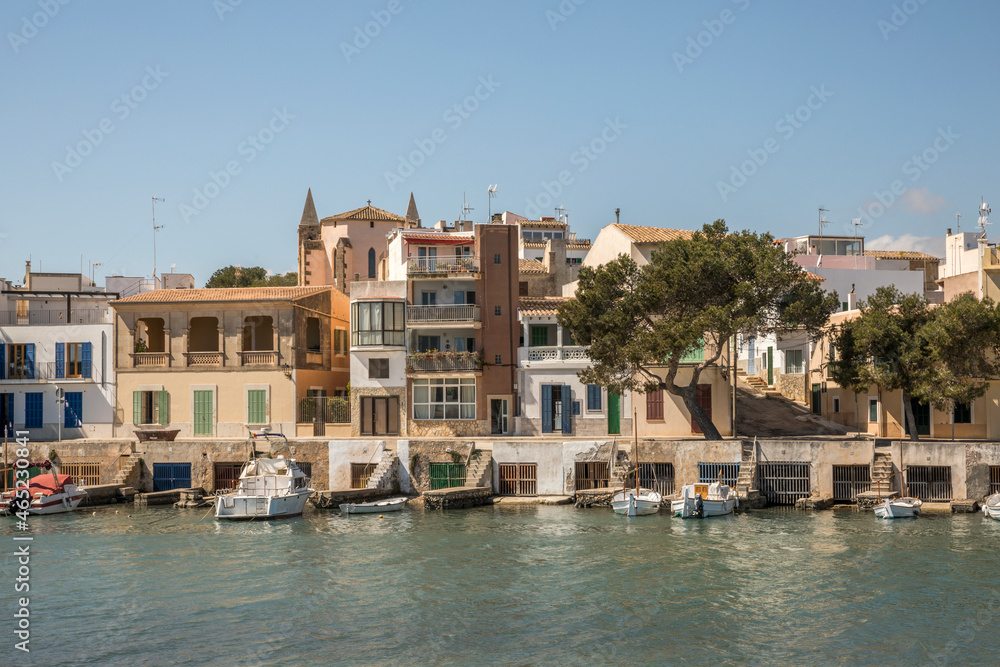 Spain, Balearic Islands, Porto Colom, Boats moored in front of waterfront houses Spain, Balearic Islands, Porto Colom, Boats moored in front of waterfront houses
