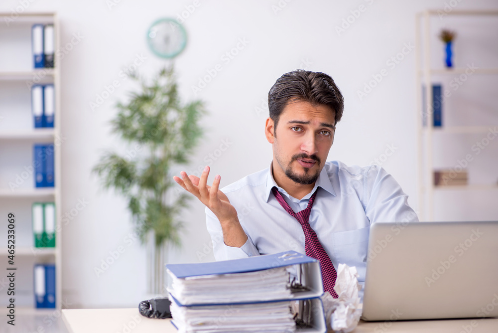 Young male employee in rejected ideas concept Young male employee in rejected ideas concept