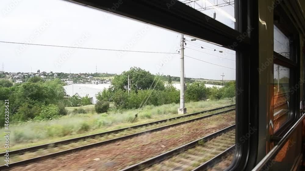 View from the railway car to the landscape passing outside the train window View from the railway car to the landscape passing outside the train window