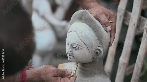 KOLKATA, INDIA - Oct 09, 2021: An unidentified man makes a clay effigy for the 'Durga Puja' festival in Kolkata.