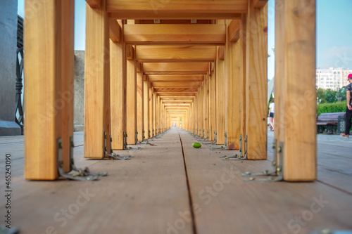 Many wooden chairs stand with each other on the street