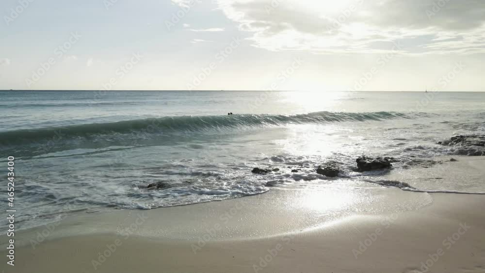 People swim against the background of waves and sun People swim against the background of waves and sun