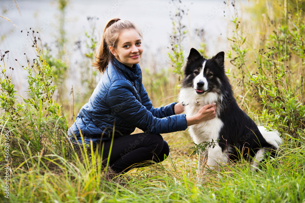 Girl sitting next to her beloved dog Girl sitting next to her beloved dog