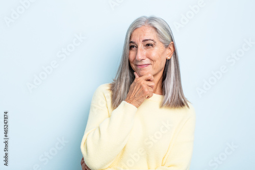 Obraz na plátně middle age gray hair woman smiling with a happy, confident expression with hand