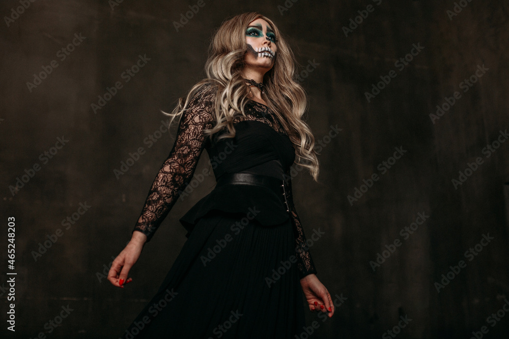 The image of a skeleton girl for Halloween. Female image for Halloween. The image of a skeleton girl for Halloween. Female image for Halloween. the woman has long blonde wavy hair, a lace black dress