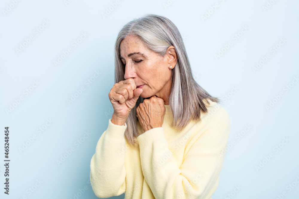 middle age gray hair woman feeling ill with a sore throat and flu symptoms, coughing with mouth covered Stock Photo | Adobe Stock middle age gray hair woman feeling ill with a sore throat and flu symptoms, coughing with mouth covered Stock Photo | Adobe Stock