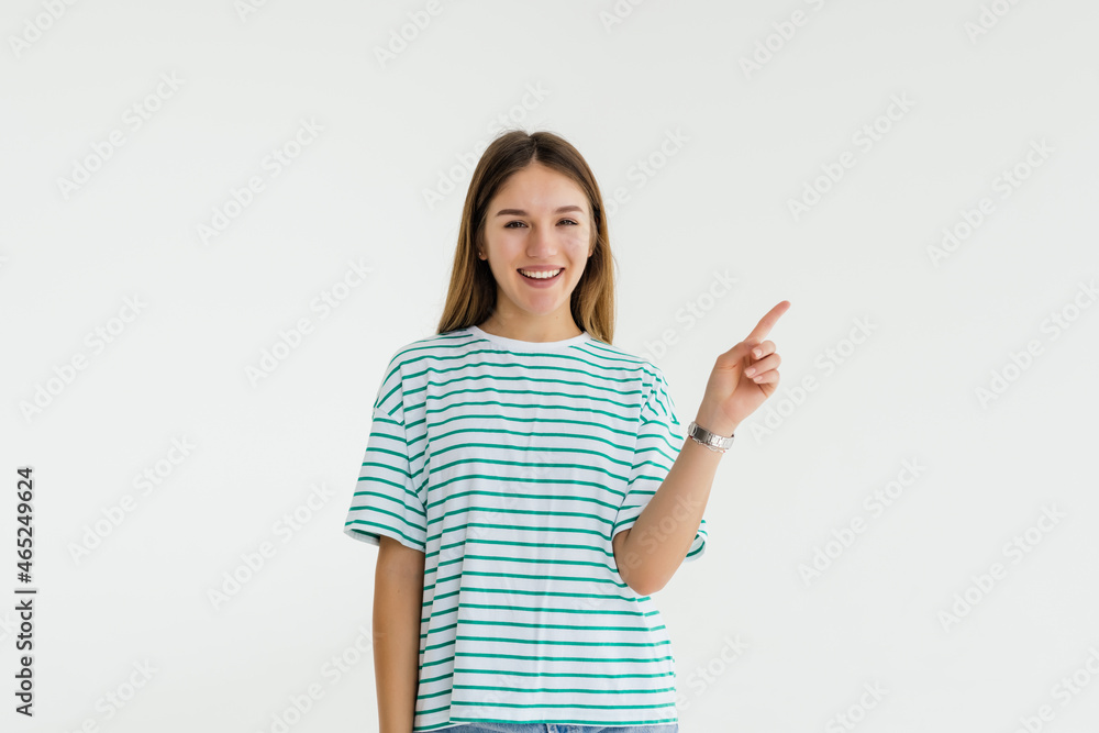 Young woman pointed side with a smile isolated on white background Young woman pointed side with a smile isolated on white background