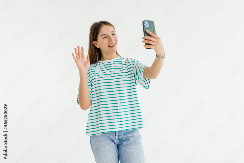 Happy young woman blogger influencer holding modern smart phone wave hand hello. Happy young woman blogger influencer holding modern smart phone wave hand hello.