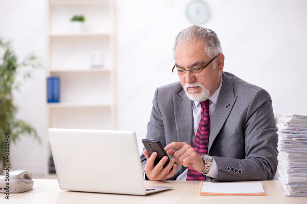 Old male employee and too much work in the office Old male employee and too much work in the office