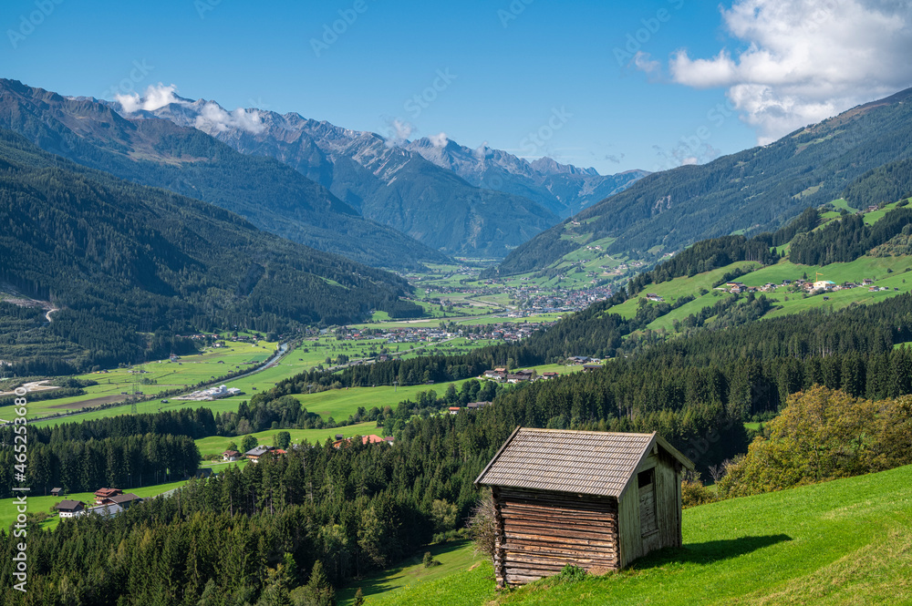 Green mountain valley in summer with shack in foreground Green mountain valley in summer with shack in foreground