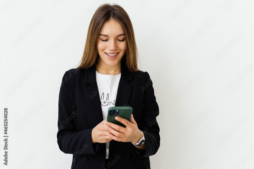 Young businesswoman use of the cellphone isolated on white background Young businesswoman use of the cellphone isolated on white background