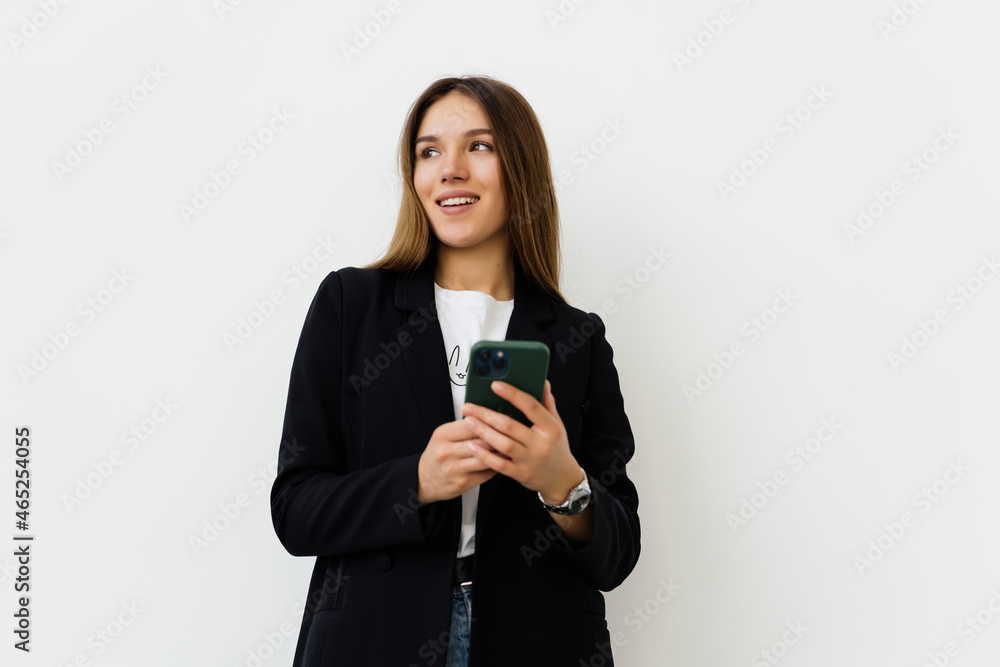 Young businesswoman use of the cellphone isolated on white background Young businesswoman use of the cellphone isolated on white background
