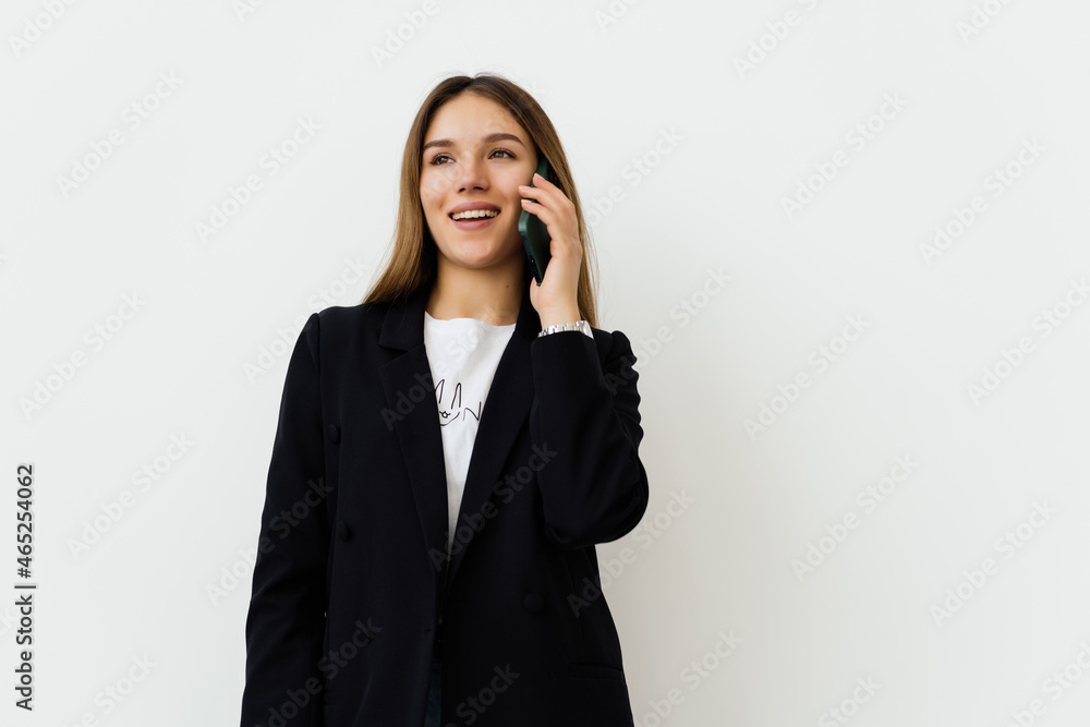 Young businesswoman talking on the mobile cell phone isolated on white background Young businesswoman talking on the mobile cell phone isolated on white background