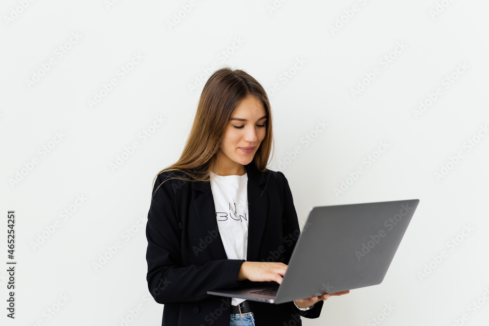 Portrait of a businesswoman working on laptop computer isolated over white background Portrait of a businesswoman working on laptop computer isolated over white background