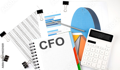 Text CFO on a notebook on the diagram and charts with calculator and pen