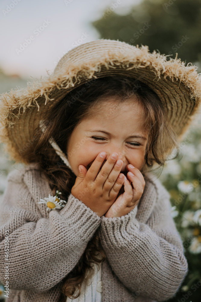 Girl covering mouth with hands while laughing Girl covering mouth with hands while laughing