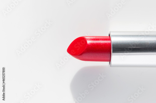 Red lipstick on white background. Beauty and cosmetics background. Decorative cosmetics  makeup  women s lipstick with shade from sun  beauty brand  product design. Flat lay top view copy space