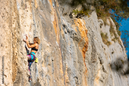 The girl climbs the rock.