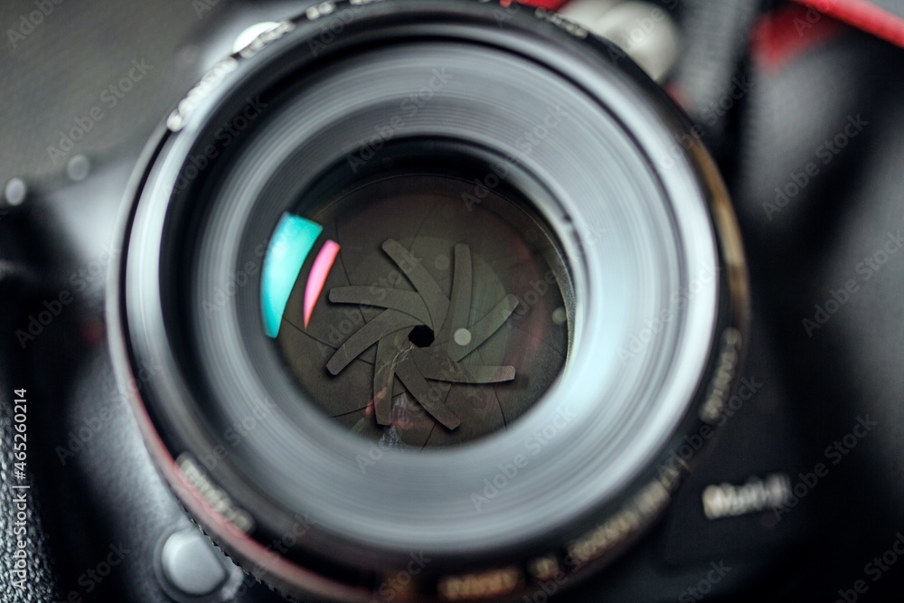 The diaphragm of a camera lens aperture. Selective focus with shallow depth of field. Color toned image. The diaphragm of a camera lens aperture. Selective focus with shallow depth of field. Color toned image.