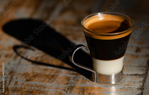 Early morning espresso coffee with condensed milk in a glass cup photo