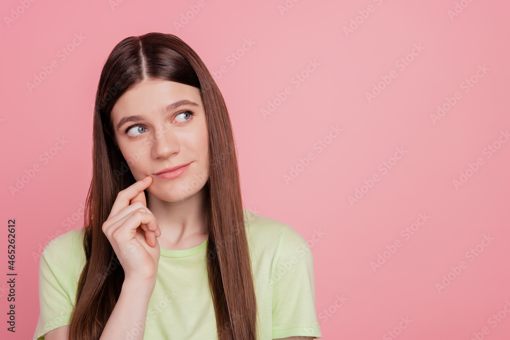 Portrait of positive cheerful girl look copyspace think thoughts look empty space isolated over pink color background Portrait of positive cheerful girl look copyspace think thoughts look empty space isolated over pink color background