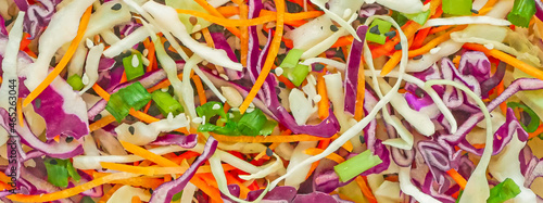 Vegetable background close-up, banner. Red cabbage and carrot vegetable salad, coleslow salad © Arylanna