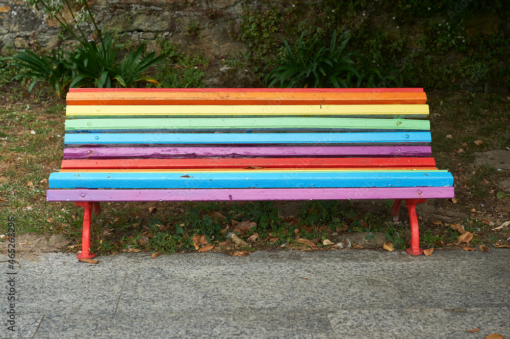 wooden slat bench painted with the colors of the LGBTI collective wooden slat bench painted with the colors of the LGBTI collective