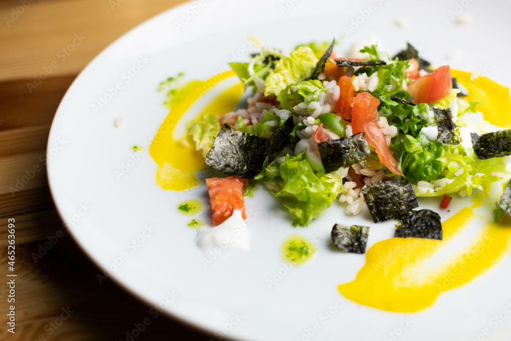 Delicious rice salad with lettuce, tomato, escarole and seaweed. Gourmet salad with natural products. Delicious rice salad with lettuce, tomato, escarole and seaweed. Gourmet salad with natural products.