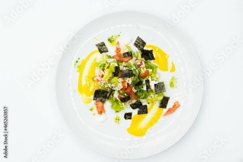 Delicious rice salad with lettuce, tomato, escarole and seaweed. Gourmet salad with natural products.