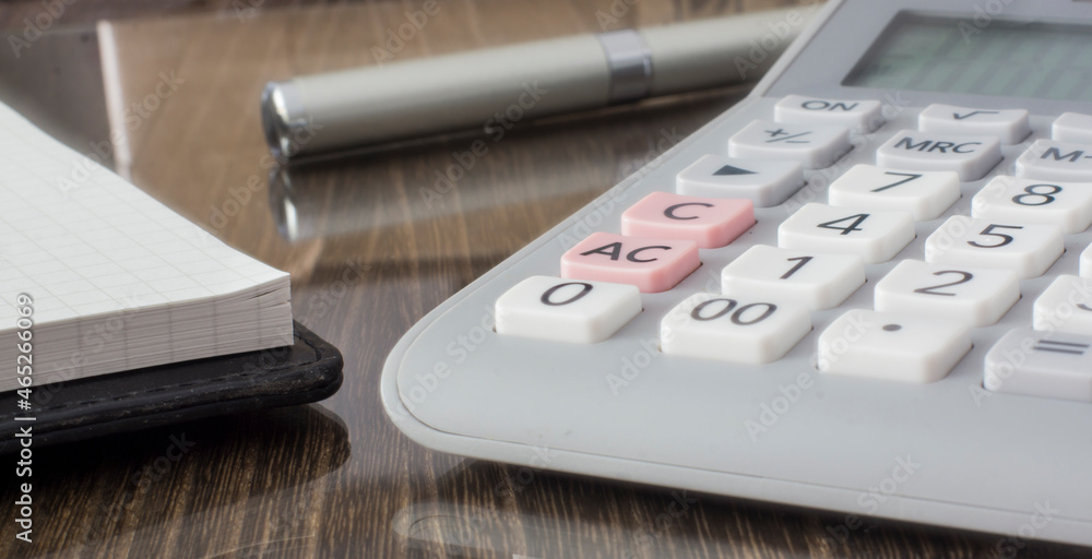 Calculator, pen and memopad on the desk. Calculator, pen and memopad on the desk.