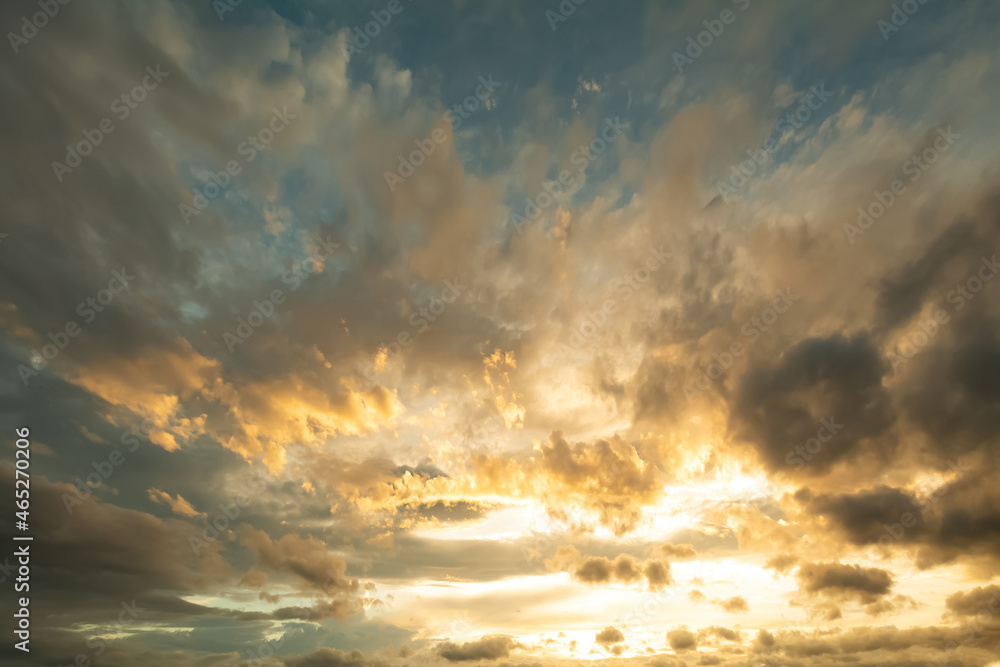 The light of the sun shines through the clouds in the morning sky. The light of the sun shines through the clouds in the morning sky.