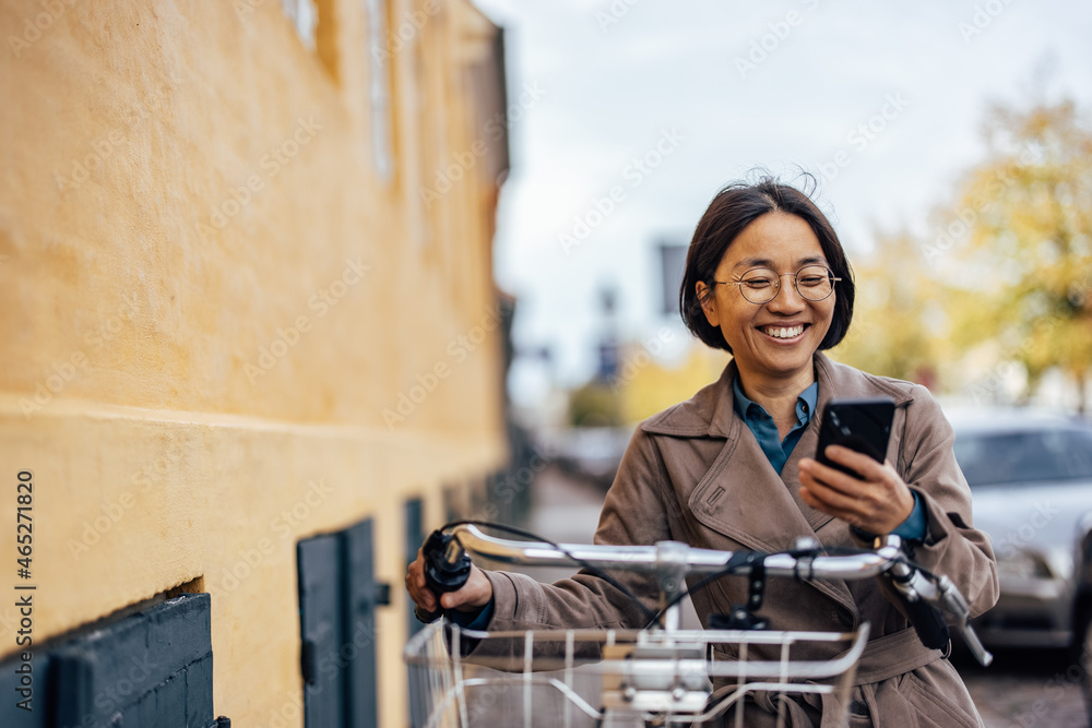 Happy Asian woman on her way to work. Happy Asian woman on her way to work.