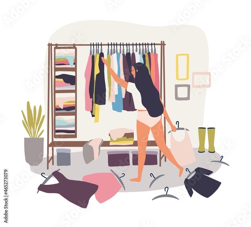 Young long-haired girl standing in front of hanger rack with clothes scattered around and trying to choose outfit. Nothing to wear concept. Cartoon colorful vector illustration in flat style