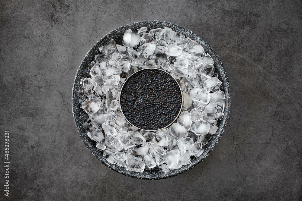 Black caviar in can on ice Black caviar in can on ice