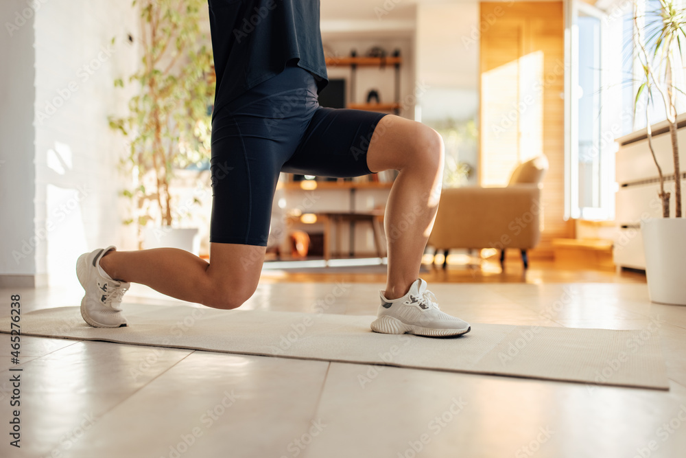 Adult woman, exercising on her yoga mat.