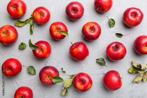 Many red apples on colored background, top view. Autumn pattern with fresh apple above view