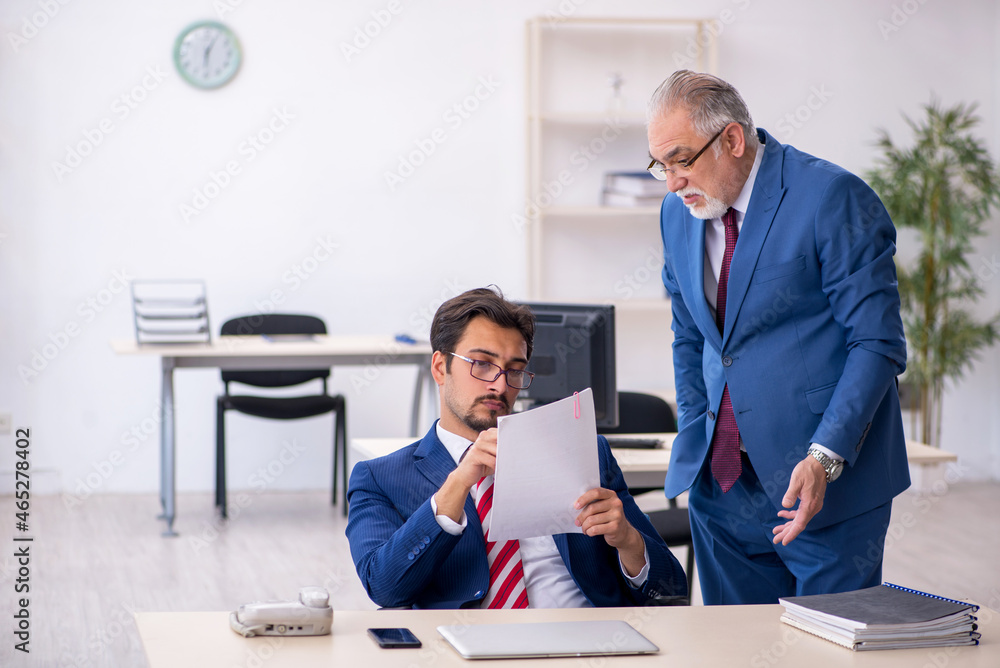 Two male colleagues working in the office Two male colleagues working in the office